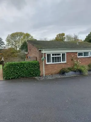 a brick house with a hedge in front of it at The Woodpeckers - Alresford Essex in Alresford