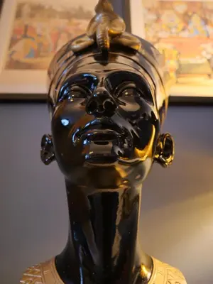 a bronze vase with a face on top of it at Chic Cottage Fireplace Patio Pet Train Stn in Wivenhoe