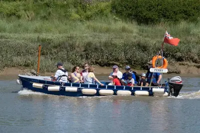 a group of people riding in a boat on the water at Chic Cottage Fireplace Patio Pet Train Stn in Wivenhoe