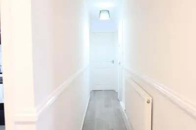 a hallway with white walls and a white door at Stunning 3 bedroom apartment in Harlow, Essex in Harlow