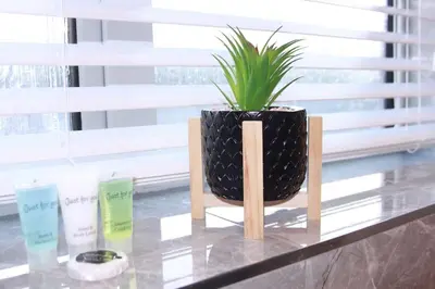 a plant in a black vase sitting on a table at Stunning 3 bedroom apartment in Harlow, Essex in Harlow