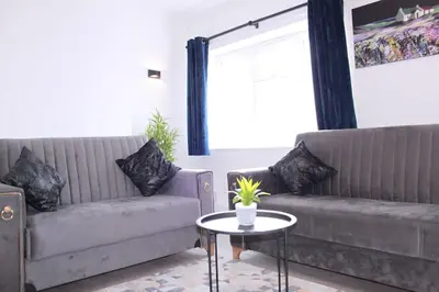 a living room with two couches and a table at Stunning 3 bedroom apartment in Harlow, Essex in Harlow