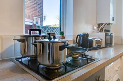 a kitchen with two pots and pans on a stove at Modern 5 Bed House with Parking in Colchester