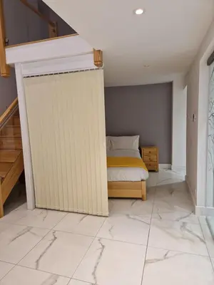 a bedroom with a bed and a wall at The Old Hay Store, Ely in Ely