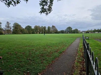 a park with a fence and a grass field at The Old Hay Store, Ely in Ely