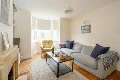 a living room with a couch and a table at 41 Eastward Ho in Leiston