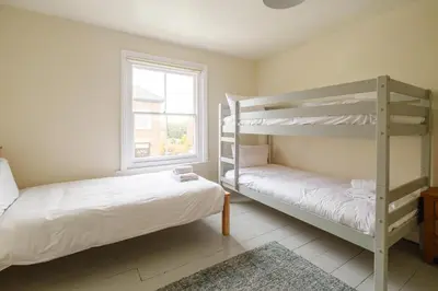 a bedroom with two bunk beds and a window at 41 Eastward Ho in Leiston
