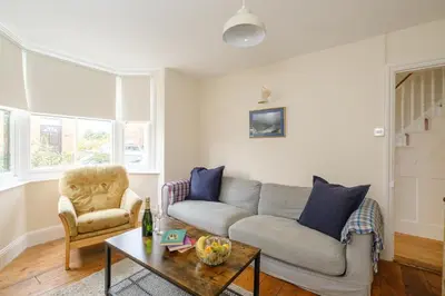 a living room with a couch and a table at 41 Eastward Ho in Leiston