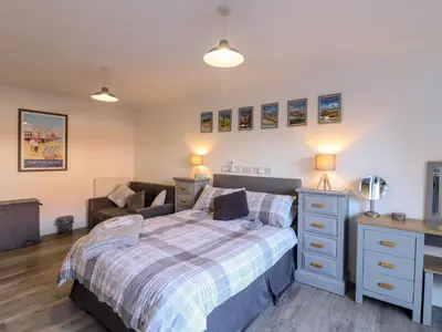 a bedroom with a bed and a desk at Little Haven in Frinton-on-Sea