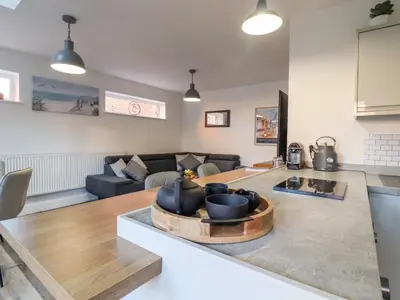a living room with a couch and a table at Little Haven in Frinton-on-Sea