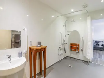 a white bathroom with a sink and a shower at Little Haven in Frinton-on-Sea
