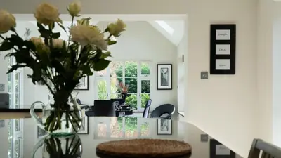 a vase of flowers on a table in a room at Superb 4BD Stay in Wyton and Houghton Village in Wyton