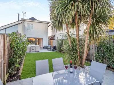 a patio with a table and chairs and a backyard at Coastal Gem in Clacton-on-Sea