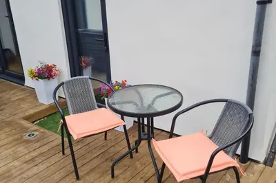 two chairs and a table on a patio at 1 Bed Sleeps 2 with Private Garden in Harlow