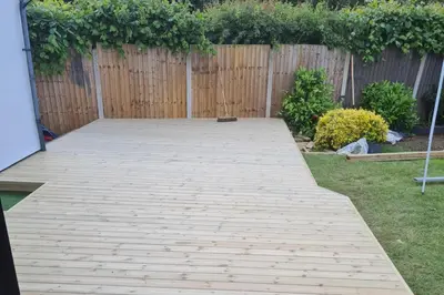 a wooden walkway in a backyard with a fence at 1 Bed Sleeps 2 with Private Garden in Harlow