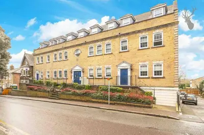 a large brick building on the side of a street at Elegant Central Brentwood Flat in Brentwood