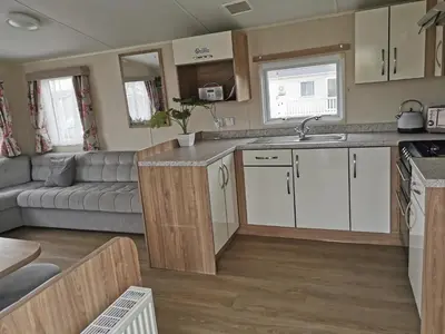 a kitchen and living room in a caravan at Cosy 3 Bedroom Beachfront Getaway in Mersea in West Mersea