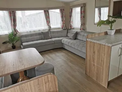 a living room with a couch and a table at Cosy 3 Bedroom Beachfront Getaway in Mersea in West Mersea
