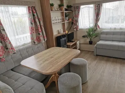 a living room with a table and a couch at Cosy 3 Bedroom Beachfront Getaway in Mersea in West Mersea