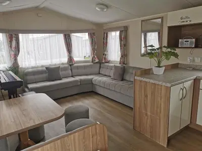 a living room with a couch and a table at Cosy 3 Bedroom Beachfront Getaway in Mersea in West Mersea