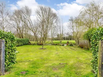 a yard with a fence and a tree in it at 3 Bed in Ipswich oc-80545 in Stowmarket