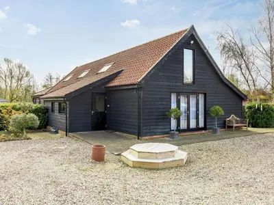 a black house with a pitched roof at 3 Bed in Ipswich oc-80545 in Stowmarket