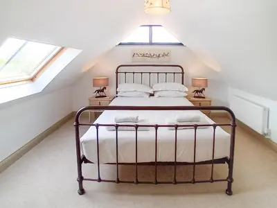 a bedroom with a bed in a attic at 3 Bed in Ipswich oc-80545 in Stowmarket