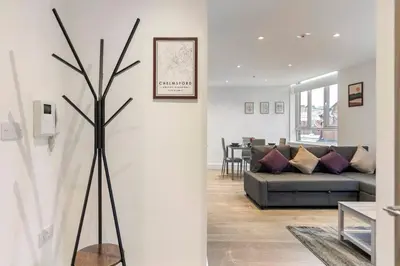 a living room with a couch and a tree at Chelmsford Centre View Sleep 4 Next Chelmer canal in Chelmsford