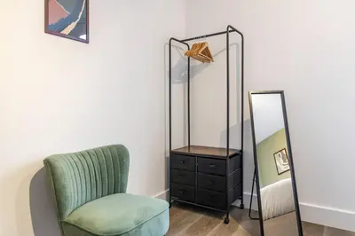 a room with a chair and a mirror at Chelmsford Centre View Sleep 4 Next Chelmer canal in Chelmsford