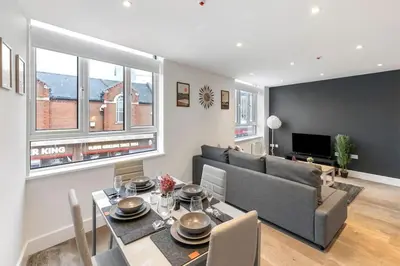 a living room with a couch and a dining room table at Chelmsford Centre View Sleep 4 Next Chelmer canal in Chelmsford