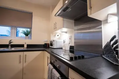a kitchen with a sink and a counter top at Cosy 2 Bedroom flat in Stevenage in Stevenage