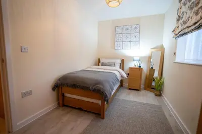 a small bedroom with a bed and a window at Cosy 2 Bedroom flat in Stevenage in Stevenage