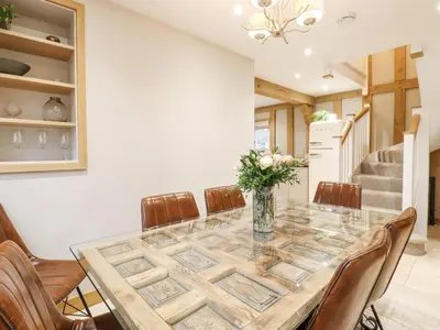 a dining room with a table and chairs at Lodge Cottage in Harwich