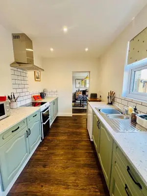 a kitchen with a sink and a counter top at Countryside Cottage By Walks & Coast, With Parking in Manningtree