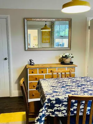 a bedroom with a table and a dresser with a mirror at Countryside Cottage By Walks & Coast, With Parking in Manningtree