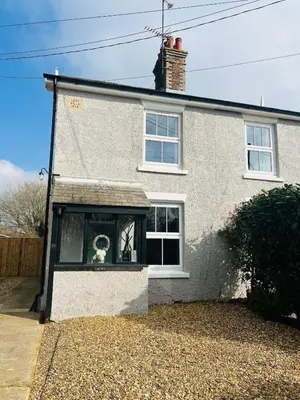 a house with a window with a dog in it at Countryside Cottage By Walks & Coast, With Parking in Manningtree