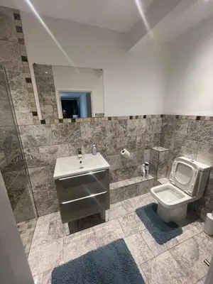 a bathroom with a sink and a toilet at Beautiful en-suite bedroom in Ipswich