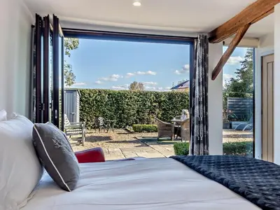 a bedroom with a bed and a large glass window at 2 Bed in Diss oc-47778 in Hopton