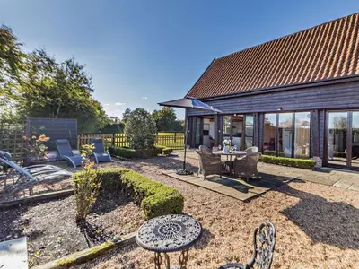 a patio with chairs and a table in a yard at 2 Bed in Diss oc-47778 in Hopton