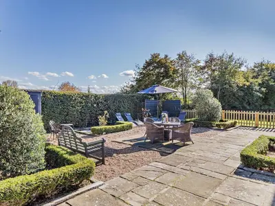 a patio with a table and chairs and an umbrella at 2 Bed in Diss oc-47778 in Hopton