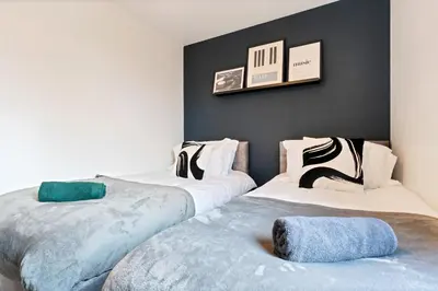 two beds sitting next to each other in a room at Stylish City Centre Apartment with Free Parking, Fast W-fi, Smart TV and Balcony by Yoko Property in Chelmsford