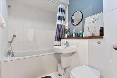 a white bathroom with a sink and a toilet at Stylish City Centre Apartment with Free Parking, Fast W-fi, Smart TV and Balcony by Yoko Property in Chelmsford