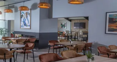 a dining room with tables and chairs at Cambridge Bar Hill Hotel, BW Signature Collection in Cambridge