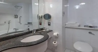 a bathroom with a sink and a toilet at Cambridge Bar Hill Hotel, BW Signature Collection in Cambridge