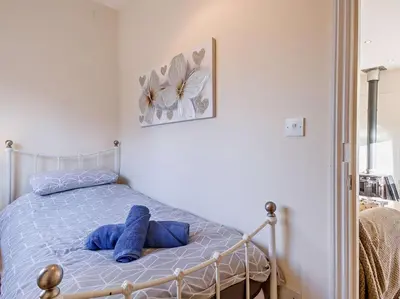 a bedroom with a bed with blue towels on it at 2 Bed in Norwich oc-64075 in East Harling