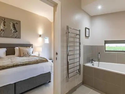 a bedroom with a bed and a bath tub at 2 Bed in Diss oc-51468 in Wortham