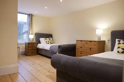 a living room with two beds and a couch at The Butcher's Block in Puckeridge