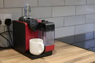 a coffee maker with a cup on a counter at The Butcher's Block in Puckeridge