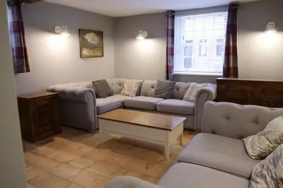 a living room with couches and a coffee table at The Butcher's Block in Puckeridge