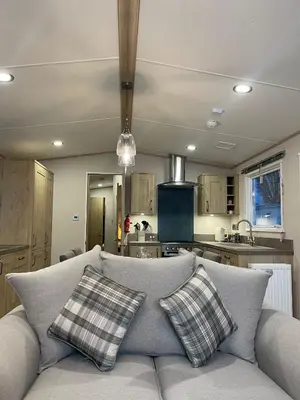 a living room with a couch and a kitchen at 3 BR - Luxury Family Home Near The Beach in East Mersea